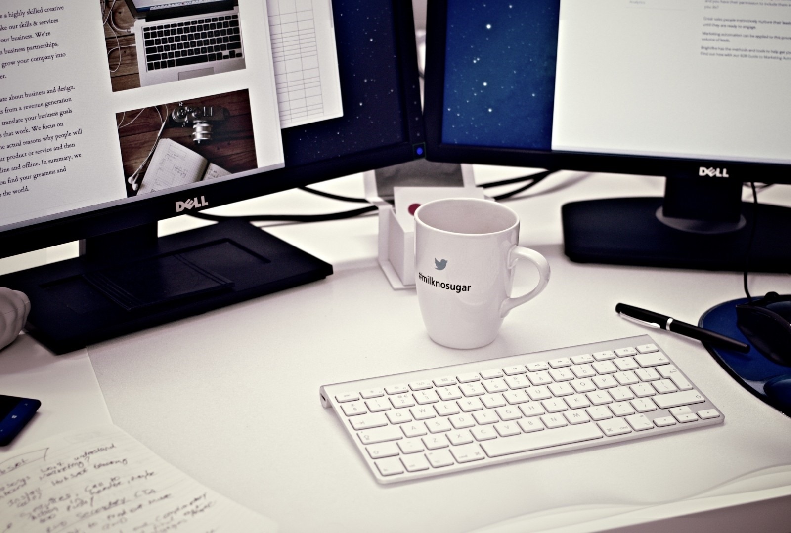 coffee-mug-and-computers-on-office-desk